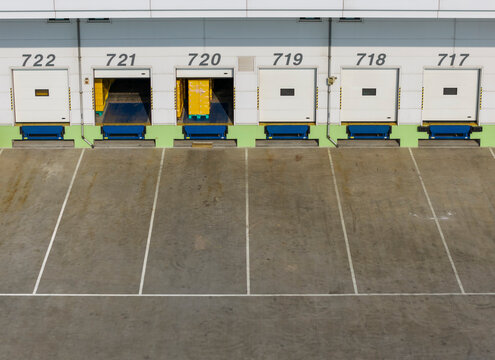 Warehouse Loading Dock with Open Bays and Cargo Pallets