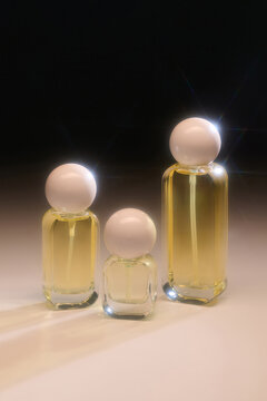 Three elegant perfume bottles stand in a row