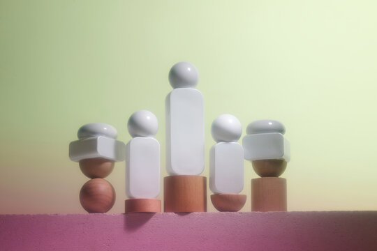 Abstract geometric figures arranged on a pink surface