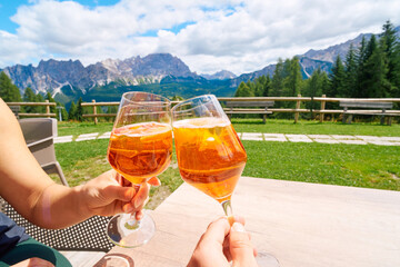 Summer Aperol Spritz Cheers with Mountain Views Italy