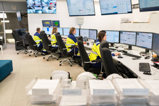 Control Room With Operators Monitoring Multiple Screens