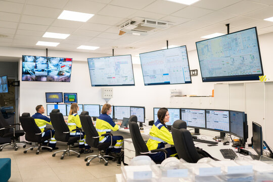 Workers Monitor Operations in a Control Center 