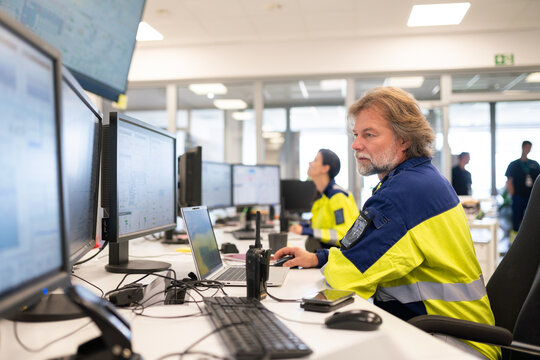 Operators Working at Control Center During Busy Shift 