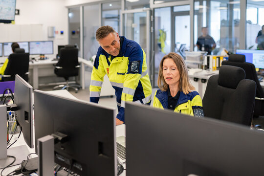 Professionals Collaborating in a Control Room 