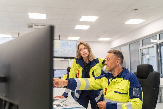 Safety Team Reviews Data in Control Room 