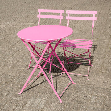 Pink metal outdoor coffee table with two chairs 