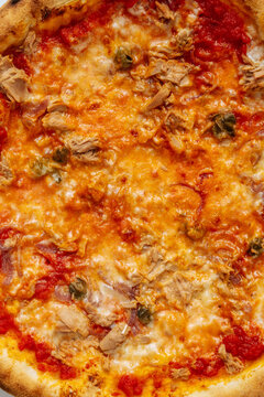 Close-up of tuna and caper pizza with tomato sauce