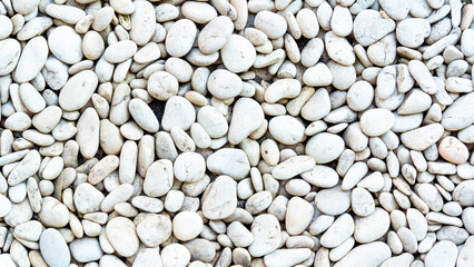 A beautiful, high-resolution, full-frame background composed of naturally polished, smooth white and off-white river pebbles, ideal for text overlays and texture use.