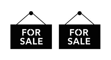 Two black signs displaying the words for sale hanging from strings