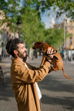 A man have fun with his dog in the city
