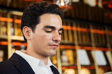 Obraz premium Young businessman in deep thought at the hotel lounge, Business corporate environment. Man relaxing at the meeting. copy space