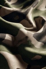 Detailed camo fabric, with earthy tones and gentle, textural folds.