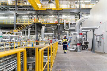 Technician Walking in a Modern Power Plant