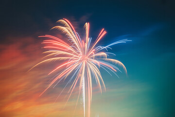 Stunning Long Exposure Fireworks Explosion in Red White and Blue Against Colorful Twilight Sky Festive Celebration Abstract Motion Light Streaks