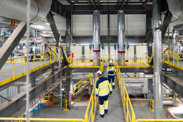 Workers Overseeing Operations in an Industrial Facility