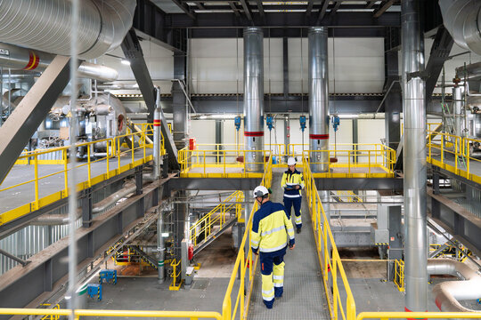 Workers Overseeing Operations in an Industrial Facility
