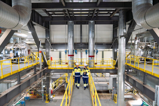 Staff Walking And Talking In Power Plant
