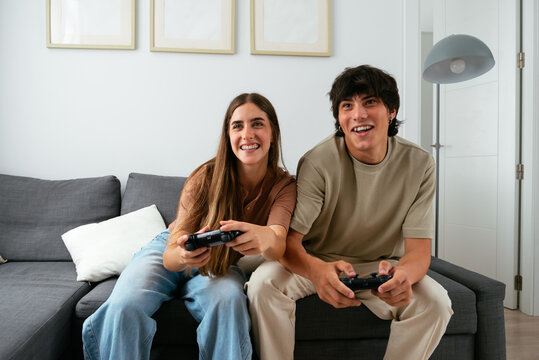 Happy Couple Playing Video Games Together at Home