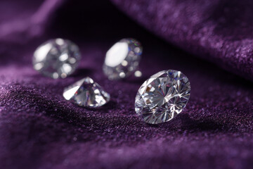 Sparkling diamonds on a plush purple velvet background, a touch of luxury.