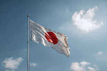The white flag with a red circle in the middle, on a cloudy sky day.