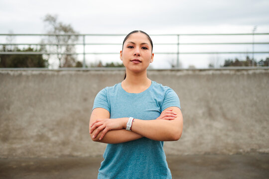 Determined Latina Woman Standing With Arms Crossed