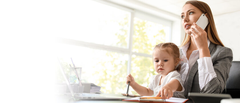 Working mother with her daughter in office - Powered by Adobe