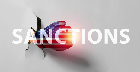 Hand in boxing glove tearing color paper