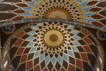 an Image focusing on the mesmerizing detail of an interior dome with elaborate, symmetrical, non-figural Islamic Geometric Dome Art
