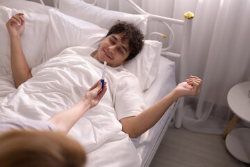 Obraz premium A happy couple with a pregnancy test result. It's a moment of joy and excitement and the joy of a man and woman on the bed for having a child, family and surprise.