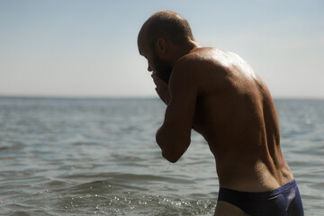 Man Enjoying a Refreshing Moment by the Calm Lake Waters