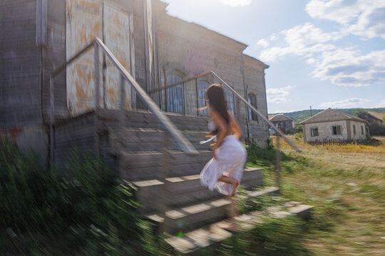 Woman Running up Stairs of An Authentic WoodenBuilding
