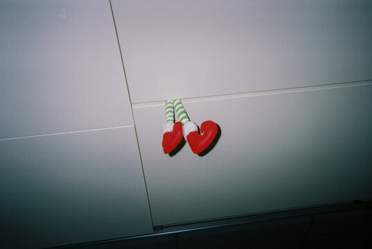 elf legs with red shoes in a cabinet, 35mm film