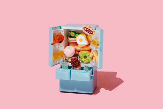 toy food spills from atoy fridge with doors open