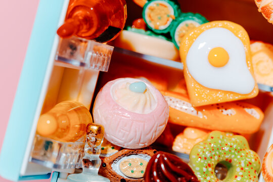 close-up of toy food inside a pastel blue refrigerator