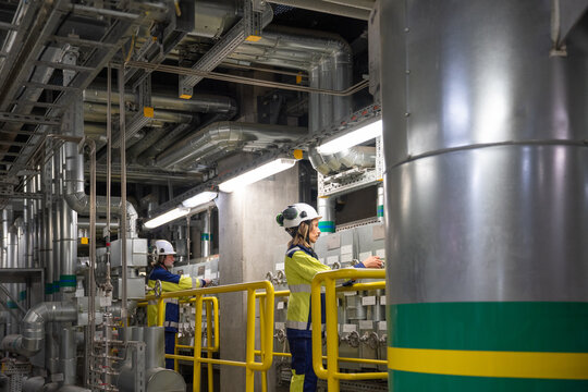 Engineers Working on Control Panel in Industrial Facility