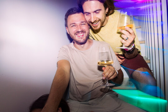 Friends Laughing and Toasting at a Party