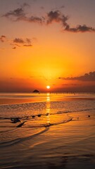 Beautiful golden sunset over an ocean, with beach and clouds