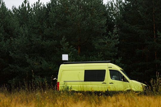 Yellow Camper Van Nestled Among Trees In Nature