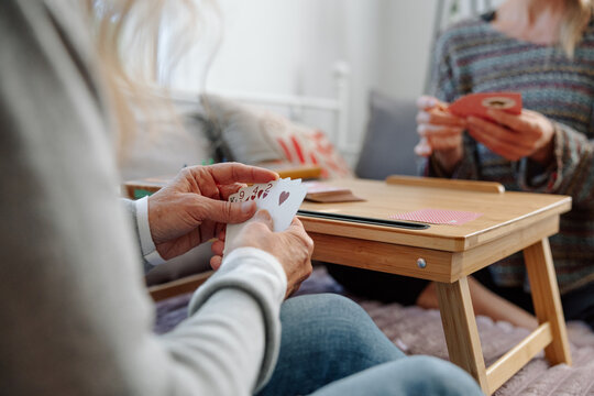 Closeup of women enjoying a friendly crib card game indoors