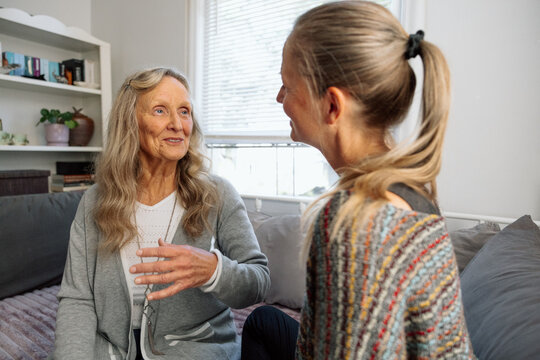 Two women having a heartfelt conversation together in a cozy home