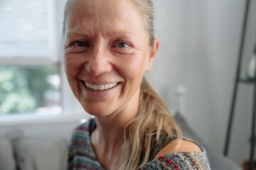 Smiling woman indoors showcasing happiness and crying for real