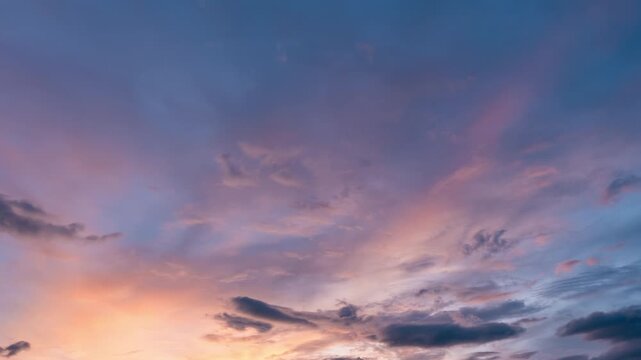 Colorful dusk sky time-lapse gradually fading into dark night with smooth cloud motion.