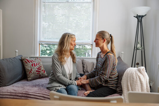 Two women sharing an emotional conversation while seated togethe