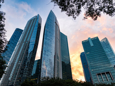 Skyscrapers glowing against sunset clouds at golden hour