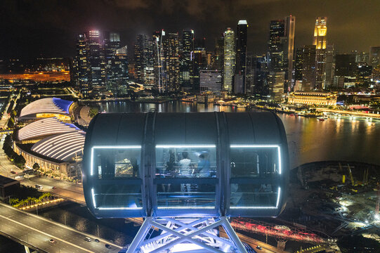 Observation ferris wheel capsule glowing with panoramic urban skyline
