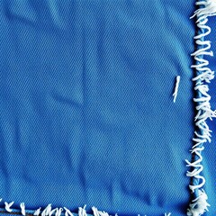 Distressed denim fabric with frayed edges, worn texture, casual and rugged style, urban vibe,  surface,  background