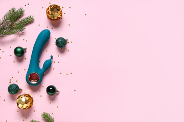 Composition with vibrator, Christmas decorations and fir branches on pink background