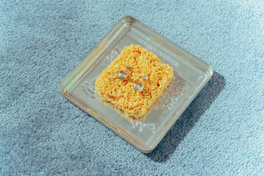 gold earrings on noodle briquette and metal tray