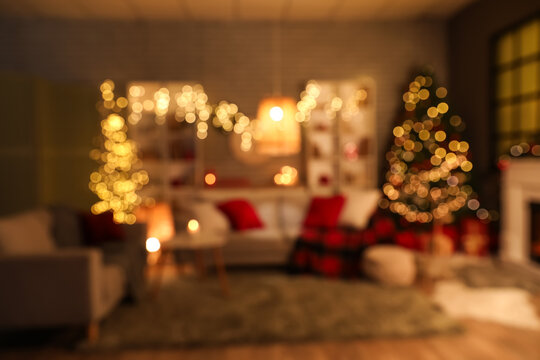 Interior of living room decorated for Christmas celebration at evening, blurred view