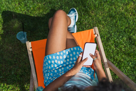 Relaxing outdoors with smartphone in hand